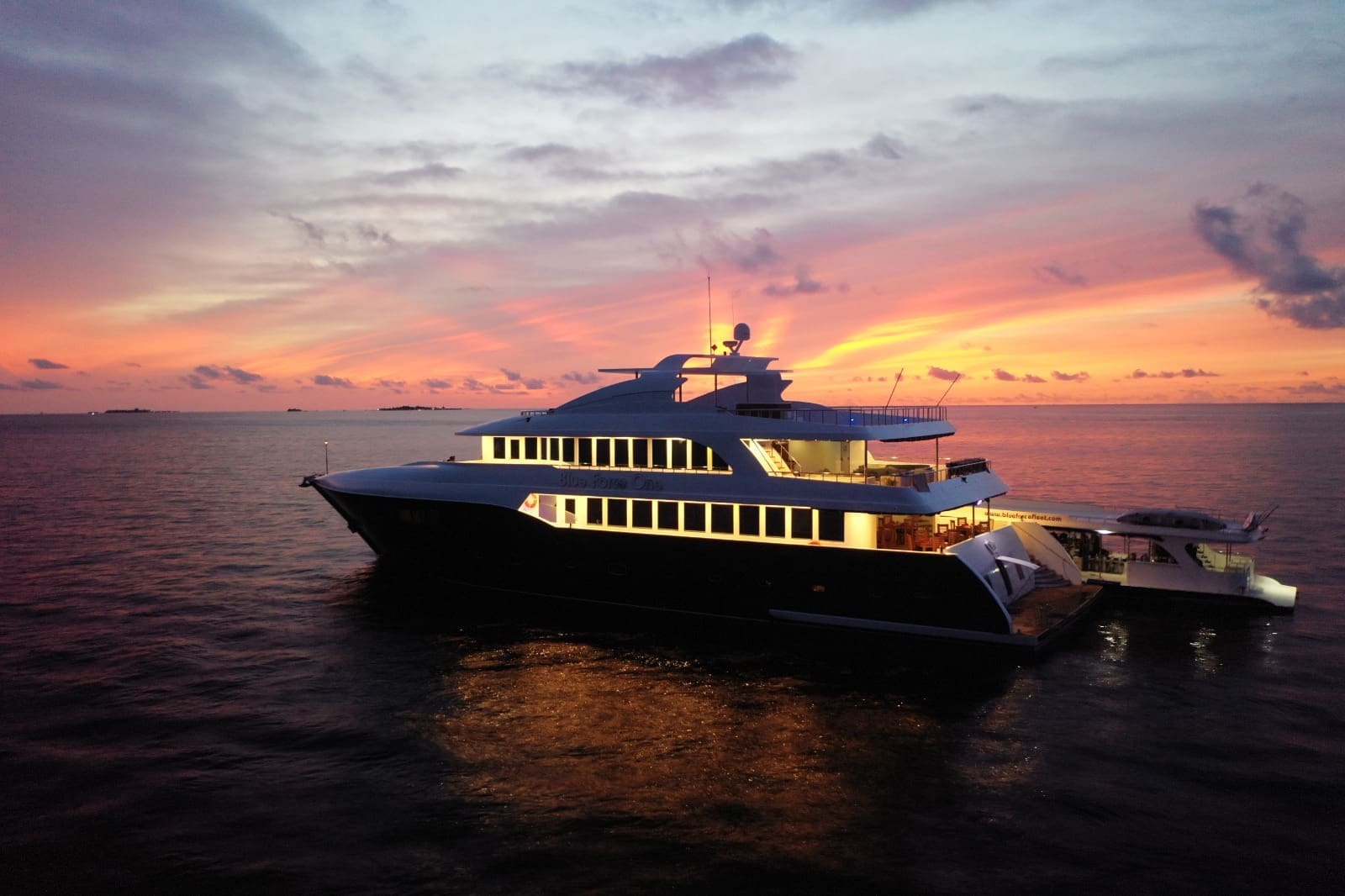 Illuminated yacht cruising at dusk