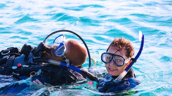 Diver providing surface support to fellow diver