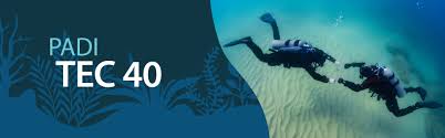 Two technical divers exploring sandy seabed