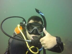 Scuba diver underwater giving thumbs up.