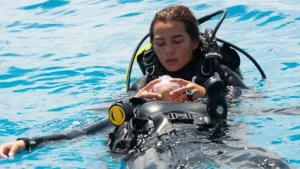 Scuba divers in the water, one unconscious.