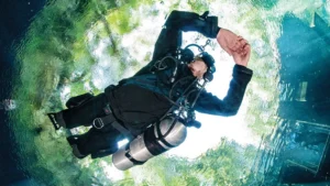 Scuba diver floating under ice hole